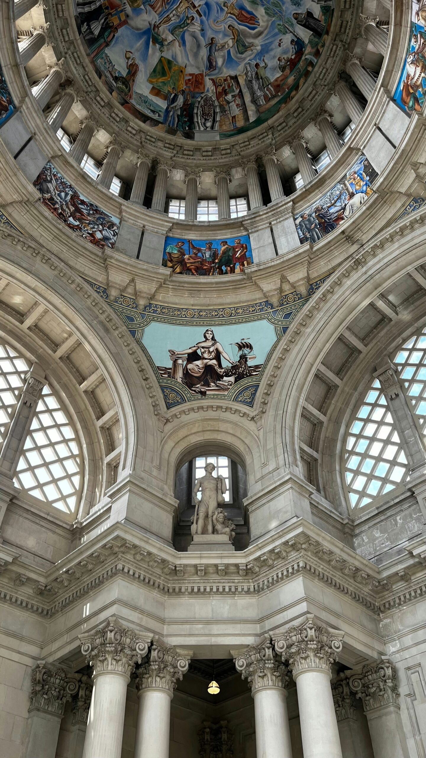 the ceiling of a large building with many paintings on it